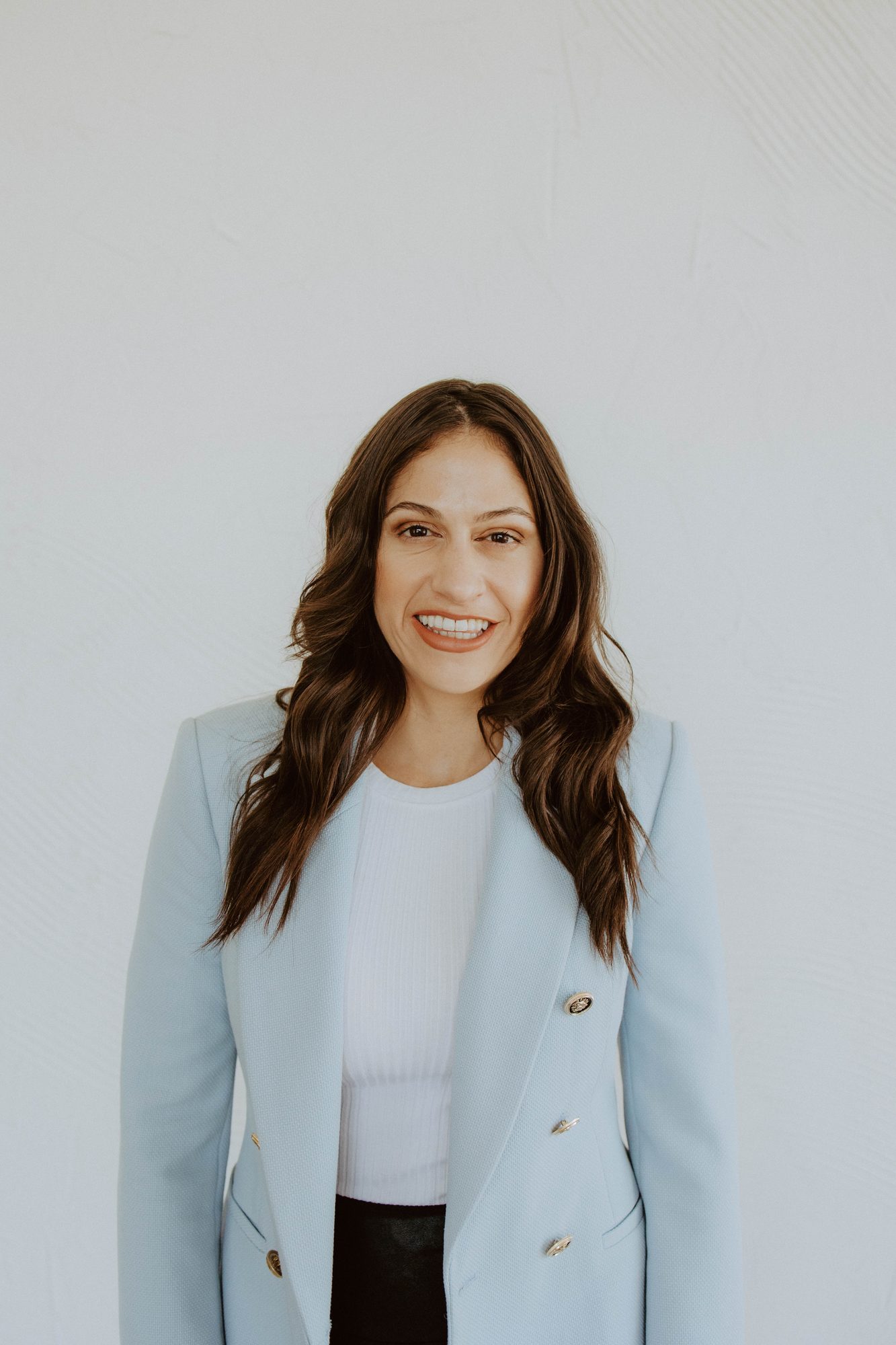 Natalie Micale Schultz wearing a light blue blazer.